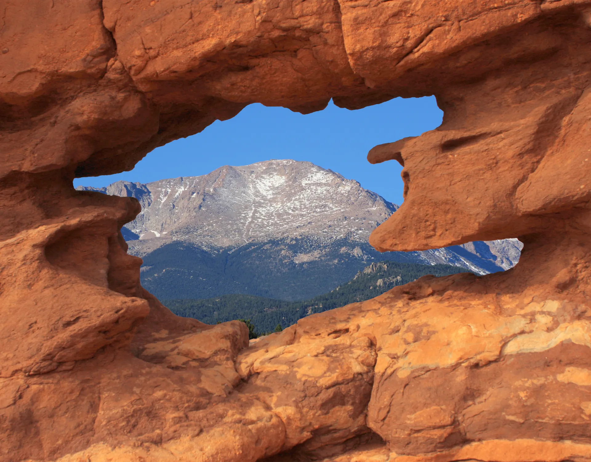 Pikes Peak framed by red rock formations in Colorado Springs